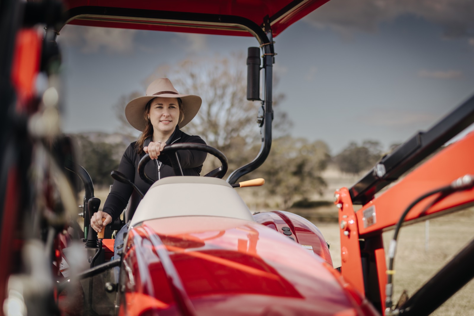 Case IH compact tractor working on farm