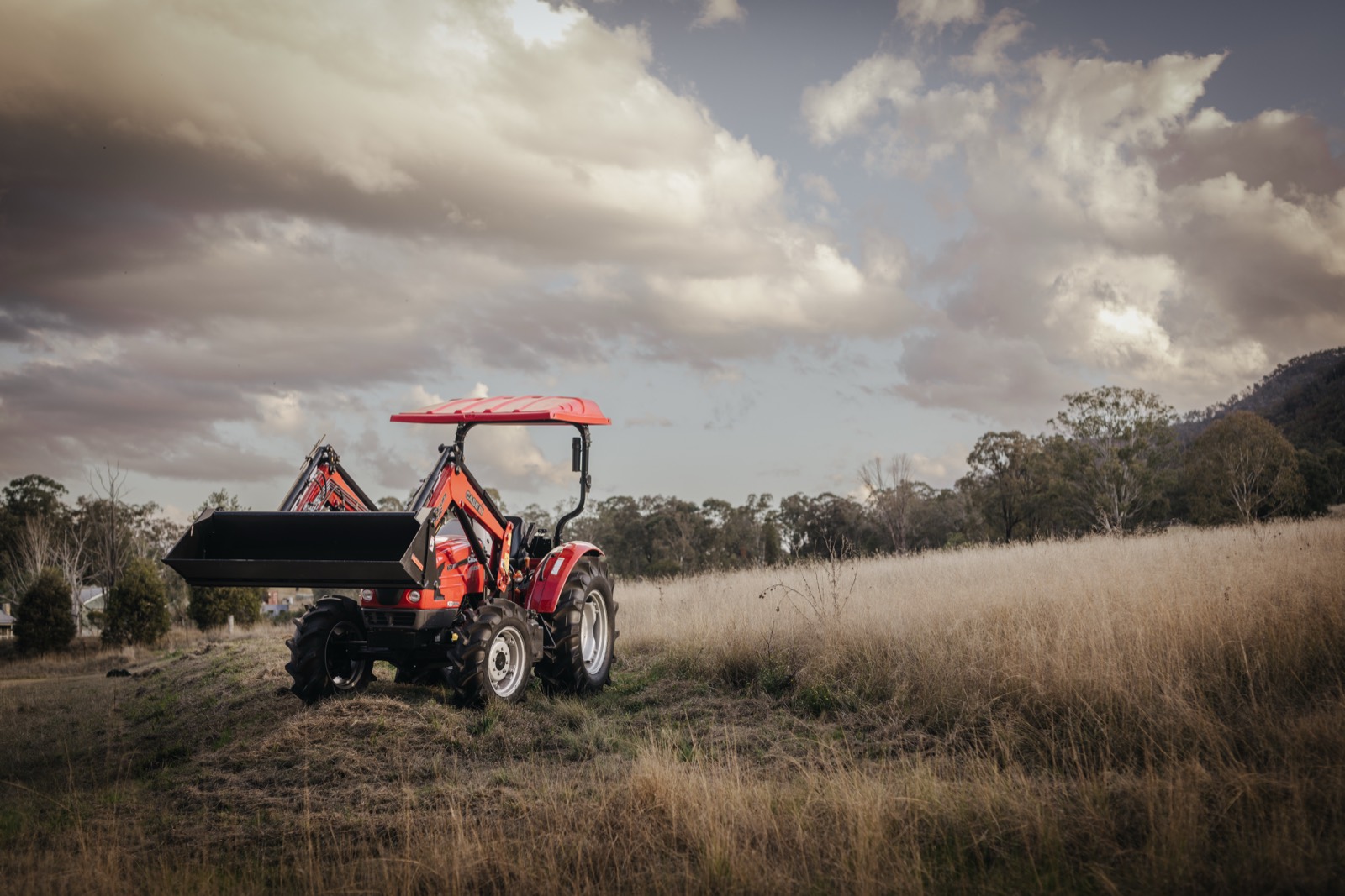 Case IH compact tractor working on farm