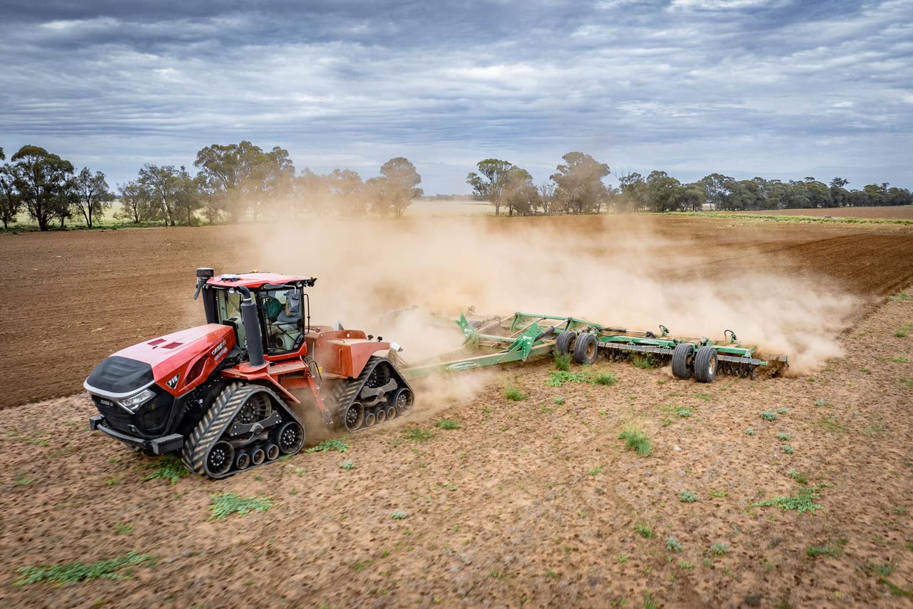 Case IH Steiger 715 Quadtrac pulling a Speedtiller through a paddock, dust rising behind