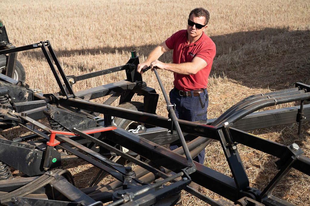 Operator setting up a Flexi-Coil Speedtiller mid-shoot