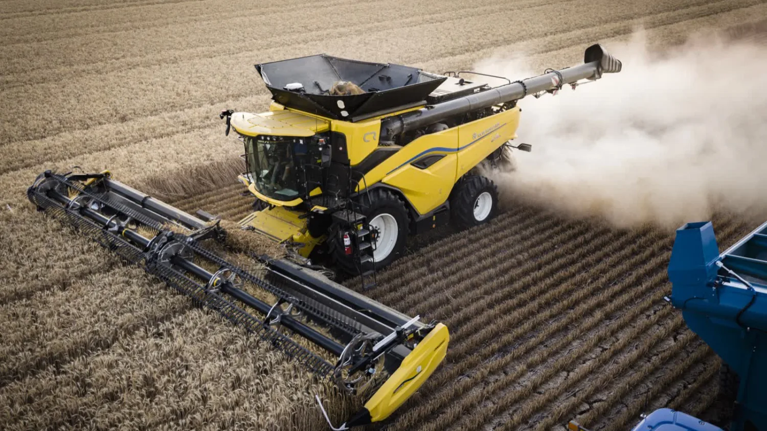 Aerial view of a yellow New Holland CR10 combine harvesting a crop near Dalby, Queensland